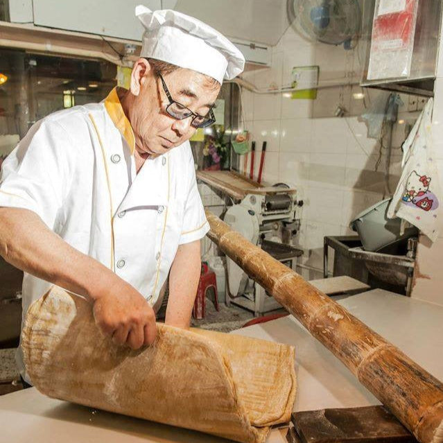 Founder making bamboo pressed noodles